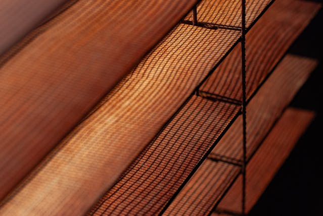 comparison of faux wood vs wood blinds care, installed in a modern interior
